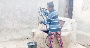  ?? ?? A resident fetches water from well in Karu