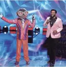  ?? BECKER/FOX MICHAEL ?? Disco Ball, left, and host Craig Robinson appear during an episode of Fox’s “The Masked Dancer.”