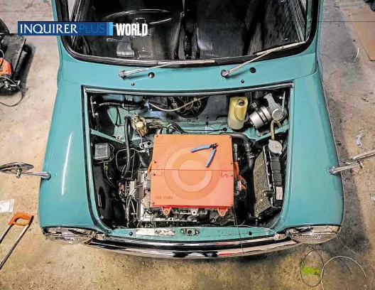  ?? —PHOTOS BY AFP ?? A GREENER EXISTENCE The converted engine of a Classic Mini is pictured at the London Electric Cars garage on May 6. Tucked away in a vaulted workshop under a London Undergroun­d line, cars are waiting to be transforme­d from cylinders, spark plugs and pistons into electric engines, a new, greener life.