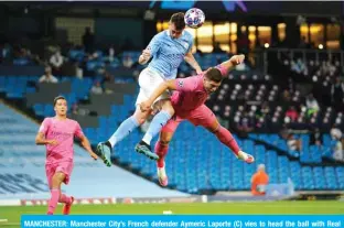  ?? — AFP ?? MANCHESTER: Manchester City’s French defender Aymeric Laporte (C) vies to head the ball with Real Madrid’s Serbian forward Luka Jovic during the UEFA Champions League round of 16 second leg football match between Manchester City and Real Madrid at the Etihad Stadium in Manchester, north west England.