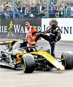  ?? — Reuters photo ?? Renault’s Nico Hulkenberg climbs out of his car after crashing at the first corner of the Belgian Grand Prix in this Aug 26 file photo.