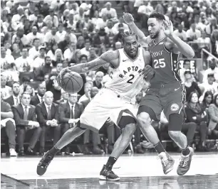  ?? - AFP photo ?? Kawhi Leonard #2 of the Toronto Raptors dribbles the ball as Ben Simmons #25 of the Philadelph­ia 76ers defends during Game Seven of the second round of the 2019 NBA Playoffs at Scotiabank Arena in Toronto, Canada.