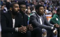  ??  ?? Boston Celtics guard Kyrie Irving (left) sit with teammates Jaylen Brown (center) and Marcus Smart during the first quarter of the team’s NBA basketball game against the Oklahoma City Thunder in Boston on Tuesday. All three starters are sidelined with...