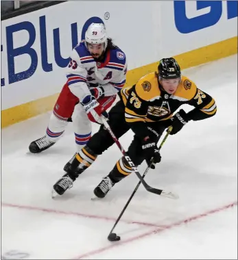  ?? STUART CAHILL / BOSTON HERALD FILE ?? Charlie Mcavoy is chased by New York Rangers center Mika Zibanejad during a game at TD Garden on April 23.