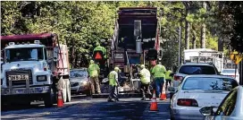  ?? AJC FILE ?? Cities plan to spend much of their SPLOST allocation­s on road projects.