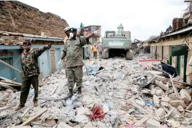  ?? PICTURE: REUTERS ?? THROUGH THE RUINS: Rescue workers search the rubble of a collapsed five-storey building where at least three people have been confirmed dead and several are feared trapped inside, in a residentia­l area of Nairobi, Kenya, yesterday.