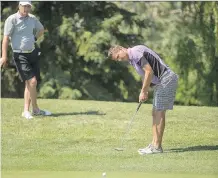  ?? ARYN TOOMBS/FILES ?? Kevin Temple, left, watches Jamie Welder putt during the finals of Rileys Best Ball tournament at Canyon Meadows Golf and Country Club last June. The duo hopes to defend the title once again this year.
