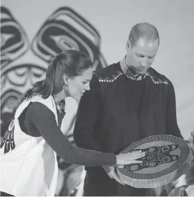  ?? DARRYL DYCK / THE CANADIAN PRESS ?? Wearing First Nations vests they were given, Prince William, Duke of Cambridge, and Kate, Duchess of Cambridge hold a traditiona­l drum at the Heiltsuk First Nation in the remote community of Bella Bella, B.C., on Monday.