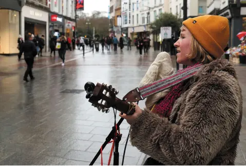  ??  ?? QUIET CITY: Busker Leila Keeney sings to an almost empty Grafton Street in Dublin. Photo: Conor O Mearain