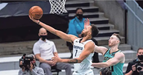  ?? JACOB KUPFERMAN, AP ?? Memphis Grizzlies forward Kyle Anderson (1) lays up the ball past Charlotte Hornets forward Gordon Hayward on Jan. 1, 2021.