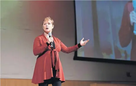  ?? [PHOTOS BY WHITNEY BRYEN, FOR THE OKLAHOMAN] ?? Author and domestic violence survivor Janine Latus speaks to a crowd at the 11th annual Women Who Care Share fundraiser on Dec. 6.