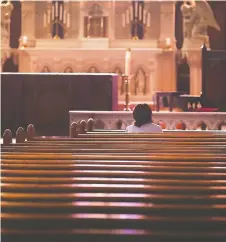  ?? DAN JANISSE ?? Roman Catholic churches in Southweste­rn Ontario remain open for private prayer. At the Assumption Church in Windsor, one woman had the church to herself around noon on Sunday.