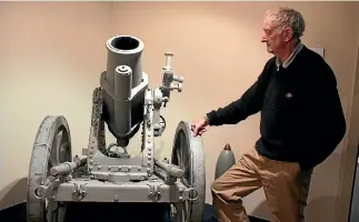  ?? MARY-JO TOHILL/STUFF ?? Owaka historian Mike McPhee beside a mine launcher (Minenwerfe­r) in Owaka Museum, the type used in World War I, which he used to play on as a child, when it was outside the memorial hall.