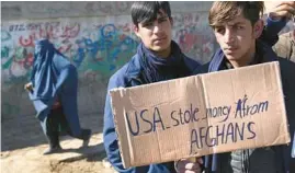  ?? HUSSEIN MALLA/AP ?? Afghans in Kabul protest President Joe Biden’s decision in February to split $7 billion in frozen Afghan assets to fund relief in Afghanista­n and compensate 9/11 victims.