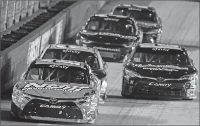  ?? Associated Press ?? Leader of the pack: Kyle Busch (18) leads the field during a NASCAR Xfinity Series auto race on Friday in Bristol, Tenn.