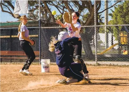  ?? ARIANA DREHSLER PHOTOS ?? Ava Cain, who plays in the Clairemont Girls Fastpitch league, makes a catch during practice at the East Clairemont Athletic Fields on Saturday. Many teams are preparing for COVID infection rates to decline enough to let youth sports resume.