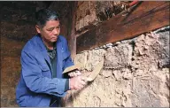  ?? HOU LIQIANG / CHINA DAILY ?? Zhang Shuhua works to repair a local temple. Zhang Shuhua, a 52-year-old carpenter in Shaxi township in Yunnan province who is now helping renovate ancient buildings