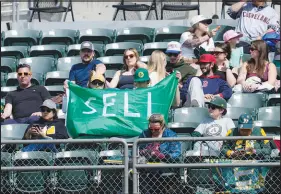  ?? JEFF CHIU / ASSOCIATED PRESS ?? Fans hold up a sign calling for Oakland Athletics management to sell the team during the fifth inning of Saturday’s game between the A’s and Cleveland Guardians in Oakland, Calif. The A’s, who plan to relocate to Las Vegas in 2028, aren’t for sale but they are looking for a place to play when their lease at the Oakland Coliseum ends this year.