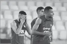  ?? AFP ?? Karim Benzema (left) appears distressed during a France training session on Saturday in Doha. Real Madrid striker Benzema was later ruled out of the World Cup due to a thigh injury.