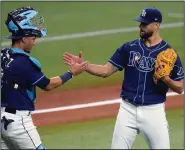  ?? (AP/Chris O’Meara) ?? Tampa Bay Rays reliever Nick Anderson (right), here celebratin­g with catcher Michael Perez after a victory over the Miami Marlins in September, posted a 0.55 ERA in 19 regular-season games. Anderson is among the top pitchers in the Rays’ vast bullpen.