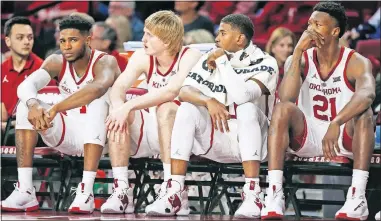  ?? [NATE BILLINGS/THE OKLAHOMAN] ?? From left, Oklahoma's Rashard Odomes, Brady Manek, Christian James and Kristian Doolittle watch from the bench late in the second half of a Jan. 28 loss to Baylor at Lloyd Noble Center in Norman.