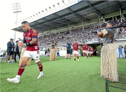  ?? GETTY IMAGES ?? Aaron Smith leads the Highlander­s on to the field for the game against the Fijian Drua in Suva last weekend. He will share the captaincy duties against the Reds tonight with James Lentjes.