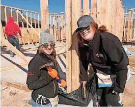  ?? [PHOTO PROVIDED BY HOMES BY TABER] ?? Elizabeth Tucker and Molly Holliday, of Homes by Taber, work on the framing of a house for Central Oklahoma Habitat for Humanity.