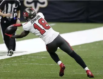  ?? AP FIle ?? SURE-HANDED: Buccaneers rookie wide receiver Tyler Johnson makes a sideline catch for a key third-down conversion against the Saints during the second half of the NFC divisional round matchup on Jan. 17 in New Orleans.