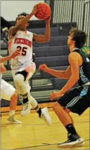  ?? BARRY TAGLIEBER - FOR DIGITAL FIRST MEDIA ?? Perk Valley’s Kevin Bernabe goes to the hoop as Daniel Boone’s Dylan Walker defends.