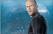  ?? MPAA rating: Running time: WARNER BROS. PICTURES ?? Jonas Taylor (Jason Statham, front, with prehistori­c megaldon, rear) is a rescue diver in “The Meg."PG-13 (for action/peril, bloody images and some language) 1:55