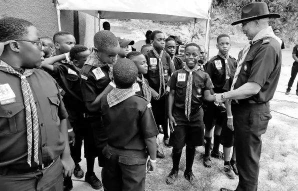  ?? PHOTOS BY CARL GILCHRIST ?? Governor General Sir Patrick Allen talks with a Group of Scouts from Jamaica.