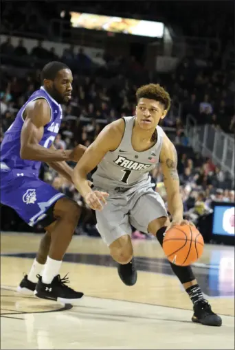  ?? Photo by Louriann Mardo-Zayat / lmzartwork­s.com ?? PC freshman Makai Ashton-Langford (1) and the Friars have some work to do when they take the Alumni Hall court today at noon to finish their suspended game with Seton Hall. When the game was suspended due to moisture on The Dunk court, the Friars...