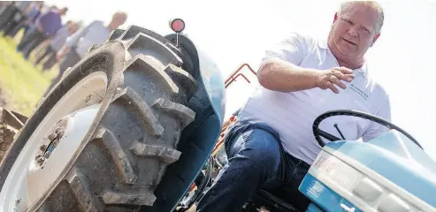  ?? GEOFF ROBINS / THE CANADIAN PRESS ?? Ontario Premier Doug Ford plows a furrow at the Internatio­nal Plowing Match in Pain Court, Ont., Tuesday.