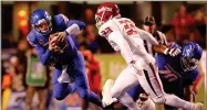  ?? AP PHOTO BY DREW NASH ?? Boise State quarterbac­k Brett Rypien (4) is tripped up by a Fresno State play for a loss during an NCAA college football game Friday, Nov. 9, in Boise, Idaho.