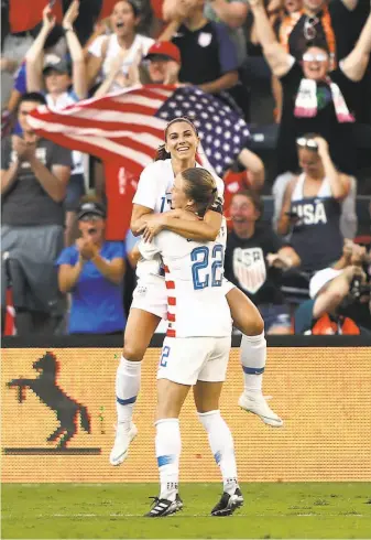  ?? Jamie Squire / Getty Images 2018 ?? Alex Morgan celebrates with Emily Sonnett (22) after scoring at the Tournament Of Nations.