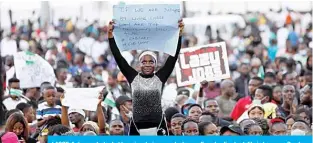  ??  ?? LAGOS: A demonstrat­or holds a sign during a protest over alleged police brutality in Lagos on Sunday.