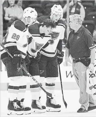  ?? NICK WASS THE ASSOCIATED PRESS ?? St. Louis Blues centre Oskar Sundqvist, second from left, is helped off the ice by right-winger Dmitrij Jaskin, second from right, and defenceman Vince Dunn during the second period of an NHL pre-season game after he was checked by Capitals forward Tom Wilson on Sunday in Washington.