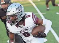  ?? GEORGE ROBINSON/ TENNESSEAN ?? Alcoa wide receiver Brandon Winton Jr. catches a pass and heads up field against Ravenwood during their season opener on Aug. 18 in Brentwood.