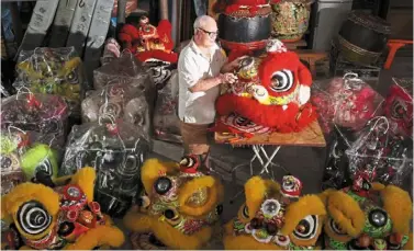  ?? — THOMAS YONG/The Star ?? Quality control: Kee inspecting lion heads at the Pak Hock Physical training associatio­n in Johor baru. He has been repairing the heads for the past 50 years.