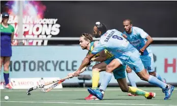  ??  ?? S.V. Sunil (left) in action against Australia in their Champions Trophy final in Breda, the Netherland­s, on Sunday.