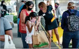  ?? COURTESY ?? People receiving food from the Yolo Food Bank. Michael Bisch with the Yolo Food Bank was one panelist at a virtual event on food insecurity during COVID-19hosted by the Yolo Community Foundation.