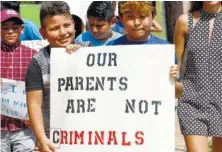  ?? AP PHOTO/ROGELIO V. SOLIS ?? Children of mainly Latino immigrant parents hold signs Sunday in support of them and those individual­s picked up during an immigratio­n raid at a food processing plant, during a protest march to the Madison County Courthouse in Canton, Miss.