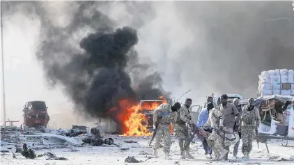  ?? PHOTO: REUTERS ?? Aftermath . . . Somali soldiers evacuate an injured colleague from the scene of an explosion in the Hodan district of Mogadishu in Somalia yesterday.