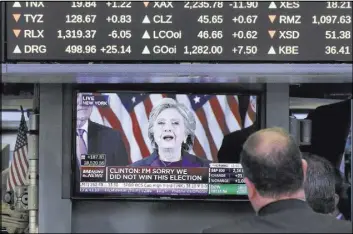  ?? RICHARD DREW/THE ASSOCIATED PRESS ?? Traders watch Hillary Clinton’s speech Wednesday, the day after her defeat on Election Day, on a television screen on the floor of the New York Stock Exchange.