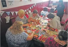  ??  ?? The ladies of Mid Argyll have a go at Mindfulnes­s Beads.