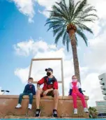  ??  ?? PALMA: A father sits with his children at Can Pere Antoni Beach in Palma de Mallorca during a national lockdown to prevent the spread of the COVID-19 disease. —AFP