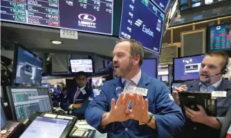  ?? RICHARD DREW/AP ?? Traders work on the floor of the New York Stock Exchange on Wednesday.