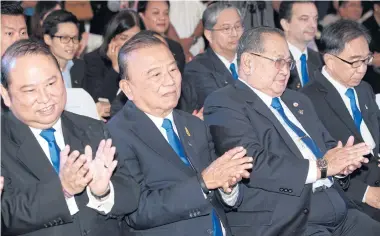  ??  ?? Mr Puttipong sits beside his father, Prasert Prasartton­g-Osoth, a former surgeon and founder of the airline, who also owns the hospital chains of Bangkok Dusit Medical Services.