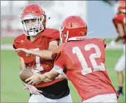  ?? MARC PENDLETON / STAFF ?? Milton-Union senior running back Dalton Hetzler (left) at preseason practice Monday.