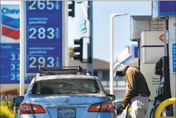  ?? Wally Skalij Los Angeles Times ?? A CUSTOMER fills up at an Arco station in Torrance this week. On July 1, the state gas tax is automatica­lly set to rise by 3.2 cents per gallon, estimated to bring in an additional $440 million in the coming fiscal year.